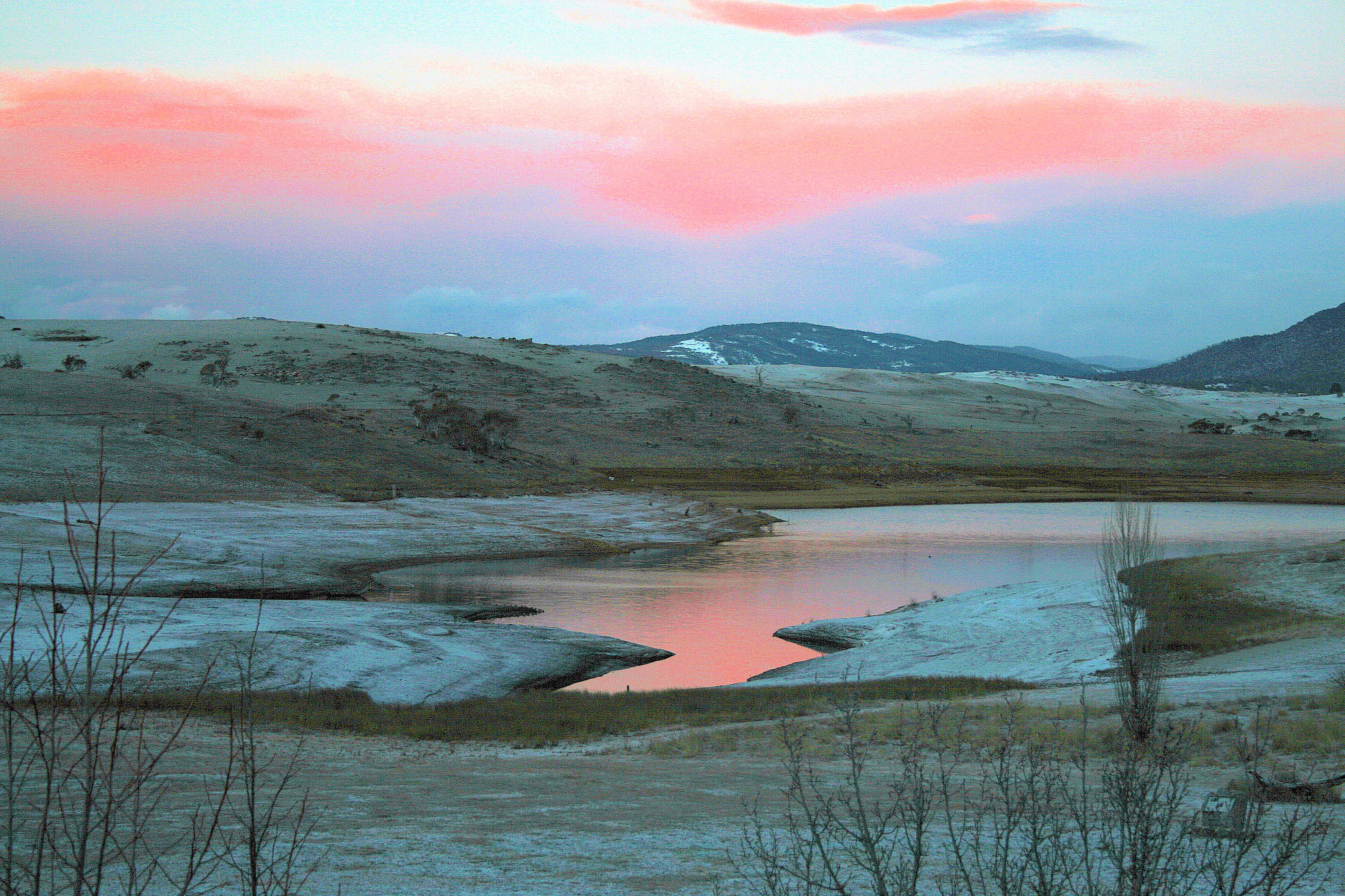 Snowy Mountains lake reflection at sunrise